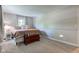 This bedroom features wall trim, carpet, two windows, and wood chest at 11510 Ralston Ave, Carmel, IN 46032