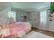 Bright bedroom with soft pink accents, large windows, and a comfortable bed creating a cheerful space at 11510 Ralston Ave, Carmel, IN 46032