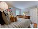 Comfortable bedroom with decorative floral art, unique lighting, and soft textures creating a cozy ambiance at 11510 Ralston Ave, Carmel, IN 46032