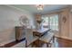 This dining room includes a wood table, upholstered chairs and a large window at 11510 Ralston Ave, Carmel, IN 46032