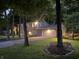 Two-story home with attached garage, illuminated by outdoor lighting, creating a warm and inviting atmosphere at 11510 Ralston Ave, Carmel, IN 46032
