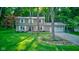 Two-story home with a lush green lawn and driveway, surrounded by mature trees at 11510 Ralston Ave, Carmel, IN 46032