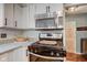 This kitchen features white cabinetry, stainless steel appliances, and granite countertops at 11510 Ralston Ave, Carmel, IN 46032