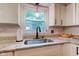 Close-up of kitchen sink area featuring granite countertops and white cabinetry at 11510 Ralston Ave, Carmel, IN 46032