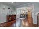 Open-concept living space with hardwood floors, a decorative clock, and view into a modern kitchen at 11510 Ralston Ave, Carmel, IN 46032