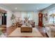 Comfortable living room with a leather sofa, decorative pillows, and hardwood floors, bathed in natural light at 11510 Ralston Ave, Carmel, IN 46032