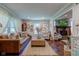 Cozy living room featuring a leather sofa, decorative pillows, and a fireplace with mounted television at 11510 Ralston Ave, Carmel, IN 46032