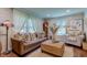 Bright living room featuring a leather sofa, a decorative coffee table, and well-lit windows at 11510 Ralston Ave, Carmel, IN 46032