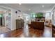 Spacious living room with a brick fireplace, hardwood flooring and a view into an adjacent sitting room at 11510 Ralston Ave, Carmel, IN 46032