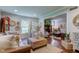 Spacious living room with a leather sofa, coffee table, and decor, connected to another living space at 11510 Ralston Ave, Carmel, IN 46032