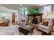 Open-concept living room with a brick fireplace, a television mounted above the mantle, and comfortable seating at 11510 Ralston Ave, Carmel, IN 46032