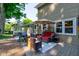 Inviting backyard with outdoor seating, a grill, a hot tub, an umbrella, and lush greenery for relaxation at 11510 Ralston Ave, Carmel, IN 46032