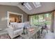 Well-decorated sunroom featuring a fire pit table, comfortable seating, and views of the backyard at 11510 Ralston Ave, Carmel, IN 46032