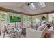 Cozy sunroom with a fire pit table, comfortable seating, and views of the backyard at 11510 Ralston Ave, Carmel, IN 46032