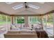 Relaxing sunroom features comfortable seating, a stone fire pit, and scenic backyard views at 11510 Ralston Ave, Carmel, IN 46032