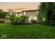 Well-maintained home backyard with verdant lawn, mulched flower beds, and inviting patio space at 11987 Quarry Ct, Fishers, IN 46037