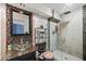 Updated bathroom showcases a glass bowl sink, decorative mosaic tiling, and frameless glass shower enclosure at 11987 Quarry Ct, Fishers, IN 46037
