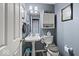 Cozy bathroom with a pedestal sink, decorative mirror, and efficient toilet at 11987 Quarry Ct, Fishers, IN 46037