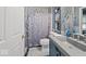 Stylish bathroom featuring a tiled shower, modern vanity with solid surface countertops, and decorative accents at 11987 Quarry Ct, Fishers, IN 46037