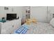 Inviting bedroom with soft lighting, a quilted comforter, and backyard view at 11987 Quarry Ct, Fishers, IN 46037