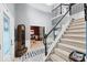 Grand foyer with staircase, neutral colors, and decorative tile, creating a welcoming entrance to the home at 11987 Quarry Ct, Fishers, IN 46037