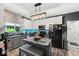 Modern kitchen with stainless steel appliances, trendy backsplash, and functional island with seating at 11987 Quarry Ct, Fishers, IN 46037