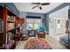 Bright living room featuring built-in bookshelves, a comfortable chair, and a view to the entry at 11987 Quarry Ct, Fishers, IN 46037