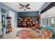 Cozy living room with extensive bookshelves, comfortable seating, and natural light at 11987 Quarry Ct, Fishers, IN 46037