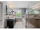 Elegant main bathroom with a glass-enclosed shower, soaking tub, and stylish vanity at 11987 Quarry Ct, Fishers, IN 46037
