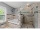 Beautiful bathroom featuring a glass-door shower, soaking tub, and tile surround at 11987 Quarry Ct, Fishers, IN 46037