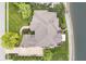 Aerial view of a brick home surrounded by green lawns, patios, and mature trees at 12192 Woods Bay Pl, Carmel, IN 46033