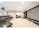 Finished basement with theater seating, projector, and ample space for entertainment at 12192 Woods Bay Pl, Carmel, IN 46033