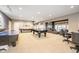 Large basement features a billiard table, game table, and a comfortable seating area at 12192 Woods Bay Pl, Carmel, IN 46033