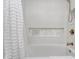 Close-up of a bathtub featuring white tile and a decorative marble mosaic tiled inset shelf at 12192 Woods Bay Pl, Carmel, IN 46033