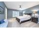 Comfortable bedroom with a queen bed, neutral walls, and ample lighting at 12192 Woods Bay Pl, Carmel, IN 46033
