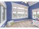 Bright bedroom boasts large windows offering a serene waterfront view and a neutral color palette at 12192 Woods Bay Pl, Carmel, IN 46033
