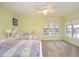 Charming bedroom with two twin beds, light green walls, and a serene view from the window at 12192 Woods Bay Pl, Carmel, IN 46033