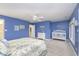 Spacious bedroom featuring blue walls, carpeted floors, and a ceiling fan with an ensuite bathroom at 12192 Woods Bay Pl, Carmel, IN 46033