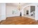 Bright dining room with wood floors, wainscoting detail, chandelier and staircase in the background at 12192 Woods Bay Pl, Carmel, IN 46033