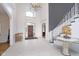Grand foyer boasts soaring ceilings, decorative chandelier, and elegant staircase creating a dramatic entrance at 12192 Woods Bay Pl, Carmel, IN 46033