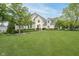 Charming home with lush lawn, manicured landscaping, and mature trees at 12192 Woods Bay Pl, Carmel, IN 46033