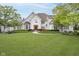 Striking stone home with lush lawn, gardens, and meticulous landscaping at 12192 Woods Bay Pl, Carmel, IN 46033