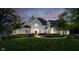 Stunning stone home with lush lawn, landscaping, and meticulous front garden at 12192 Woods Bay Pl, Carmel, IN 46033