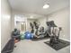 Home gym with various exercise equipment and a large mirror for monitoring form at 12192 Woods Bay Pl, Carmel, IN 46033