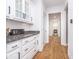 Hallway with white cabinets, granite countertops, and hardwood floors at 12192 Woods Bay Pl, Carmel, IN 46033