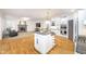 Open-concept kitchen with granite island and connecting living room at 12192 Woods Bay Pl, Carmel, IN 46033