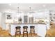 Well-lit kitchen with granite countertops, stainless steel appliances, and island seating at 12192 Woods Bay Pl, Carmel, IN 46033