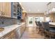 Well-lit kitchen boasts stone counters, mosaic backsplash, wine rack, and stainless steel appliances at 12192 Woods Bay Pl, Carmel, IN 46033