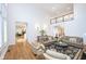 Well-lit living room with hardwood floors, two-story ceiling and comfortable couches at 12192 Woods Bay Pl, Carmel, IN 46033
