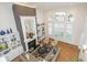 Aerial view of a well-lit living room with fireplace and large windows at 12192 Woods Bay Pl, Carmel, IN 46033